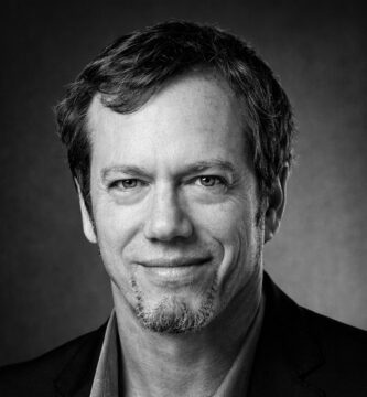 Ritratto in bianco e nero di Robert Greene, autore e saggista statunitense, noto per le sue frasi su potere, strategia, psicologia umana e dinamiche di controllo – Il Meglio dei Libri